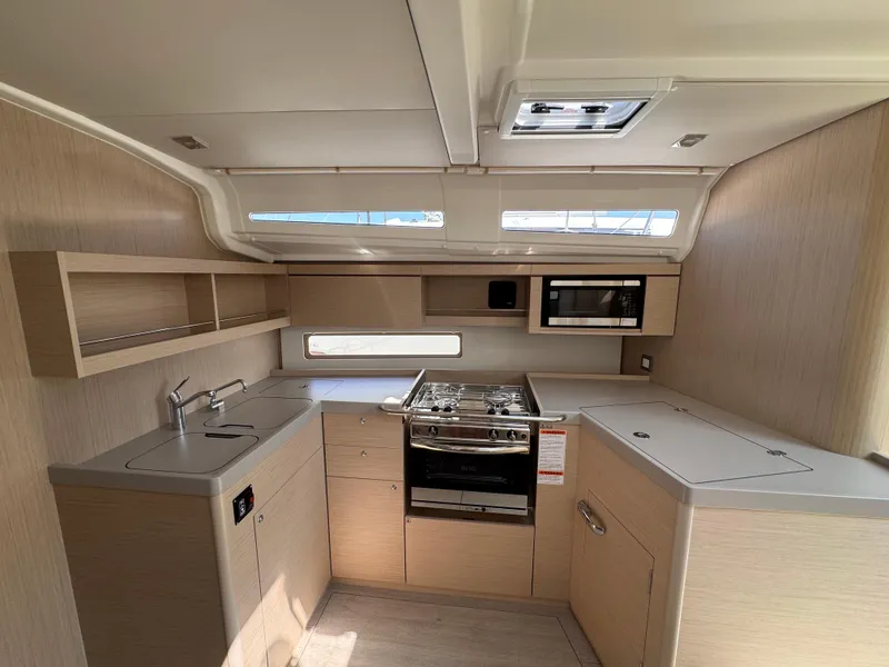 Slide: The Image of Modern kitchen interior of 2025 Beneteau Oceanis 40.1 yacht with stove and microwave. - 12