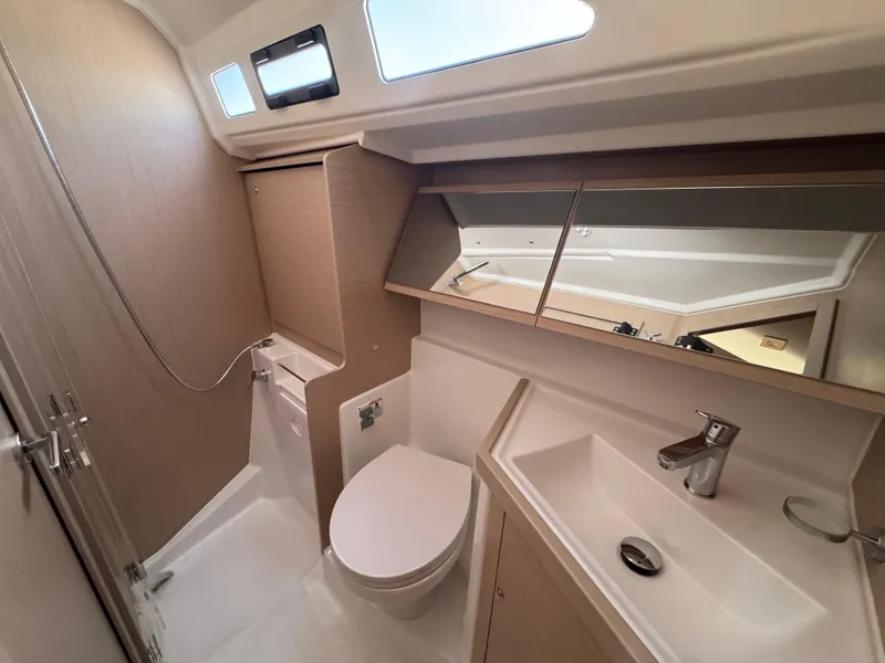 Slide: The Image of Modern bathroom in 2025 Beneteau Oceanis 40.1 yacht, featuring sleek fixtures and ample storage. - 14