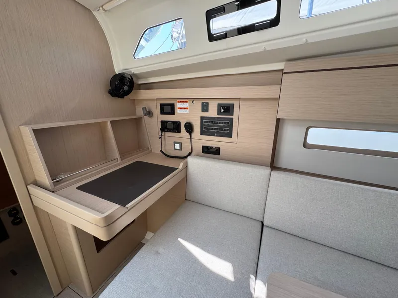 Slide: The Image of Interior of 2025 Beneteau Oceanis 40.1 yacht, featuring modern navigation station and light wood finish. - 15
