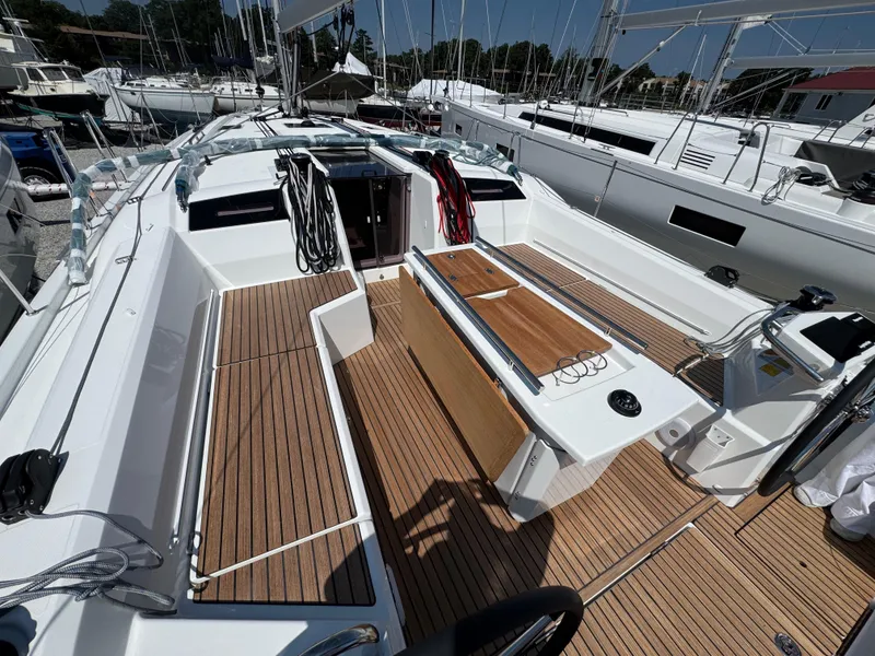 Slide: The Image of 2025 Beneteau Oceanis 40.1 sailboat cockpit with teak flooring and modern design. - 3