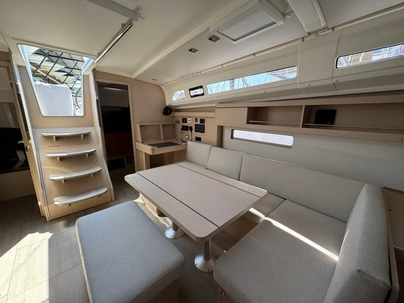 Slide: The Image of Interior of 2025 Beneteau Oceanis 40.1 yacht, featuring modern seating and dining area. - 4