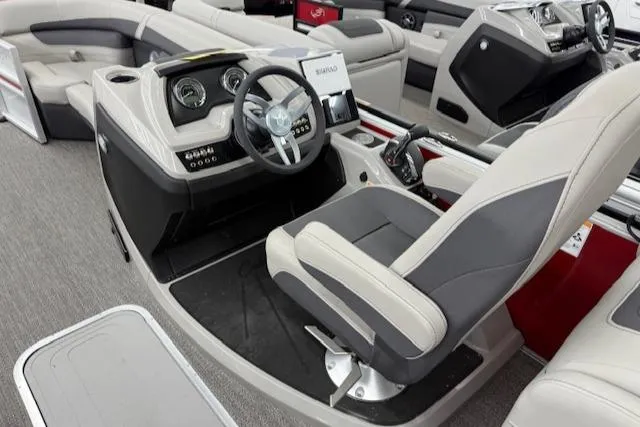 Slide: The Image of 2025 Barletta Cabrio 22QC boat interior with modern steering console and comfortable seating. - 11