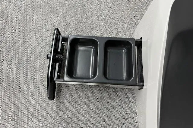 Slide: The Image of Cup holder in 2025 Barletta Cabrio 22QC boat, featuring dual compartments on a textured surface. - 2