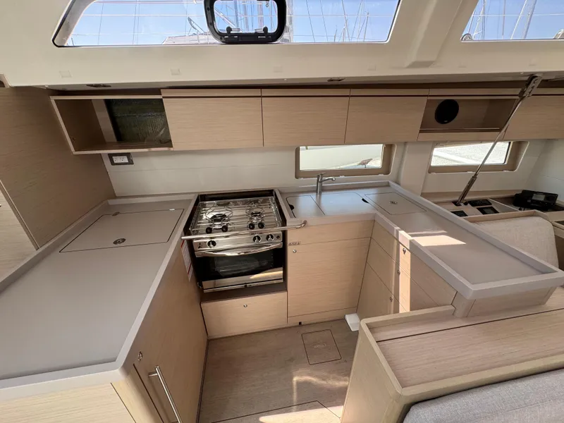 Slide: The Image of 2024 Beneteau Oceanis 51.1 yacht interior kitchen with modern appliances and sleek design. - 10
