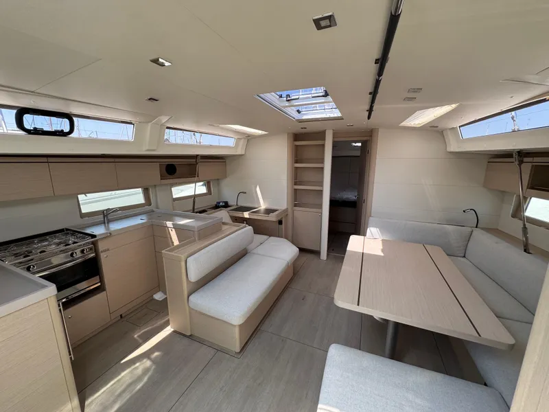 Slide: The Image of Luxurious interior of 2024 Beneteau Oceanis 51.1 yacht with modern kitchen and seating area. - 16