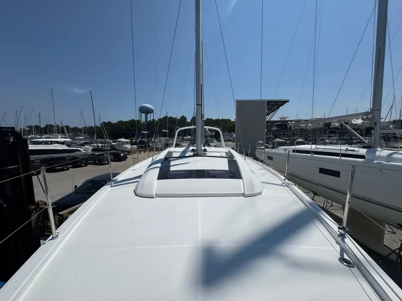 Slide: The Image of 2024 Beneteau Oceanis 51.1 yacht on display at marina, showcasing sleek deck design. - 3