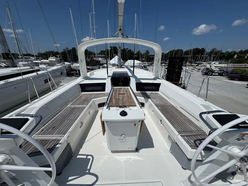 Slide: The Image of 2024 Beneteau Oceanis 51.1 yacht cockpit with dual steering wheels and spacious seating. - 8