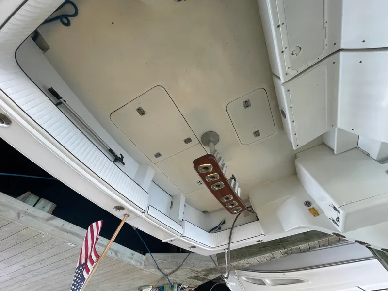 Slide: The Image of 1998 Hatteras 39 Sport Express boat deck with storage compartments and American flag. - 15