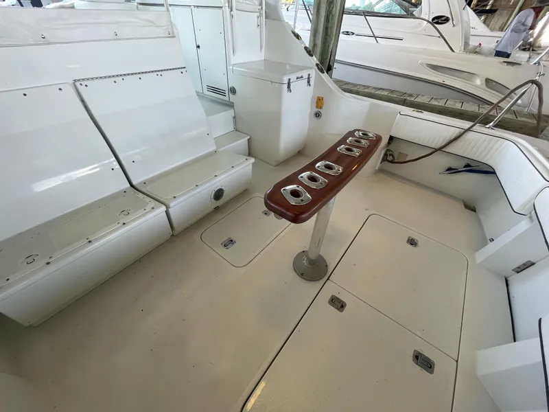 Slide: The Image of 1998 Hatteras 39 Sport Express boat interior with seating and rod holders. - 16