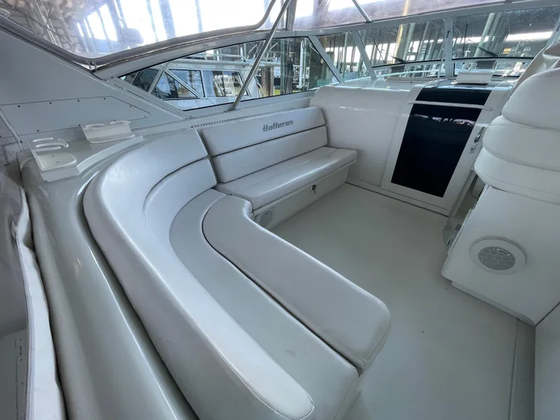 Slide: The Image of 1998 Hatteras 39 Sport Express interior with white seating and sleek design. - 18