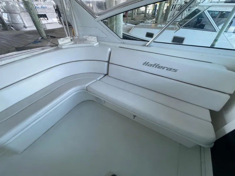 Slide: The Image of 1998 Hatteras 39 Sport Express boat interior with white cushioned seating. - 22