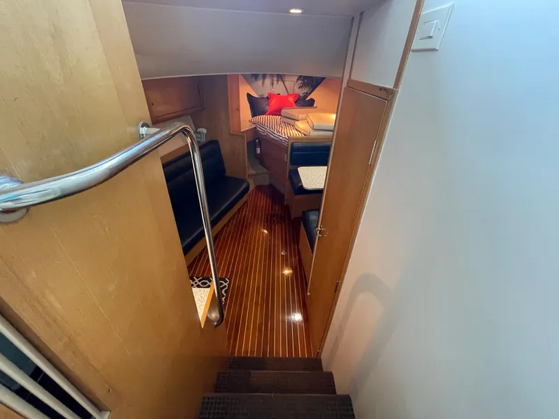 Slide: The Image of Interior of 1998 Hatteras 39 Sport Express yacht with polished wood flooring and seating area. - 23