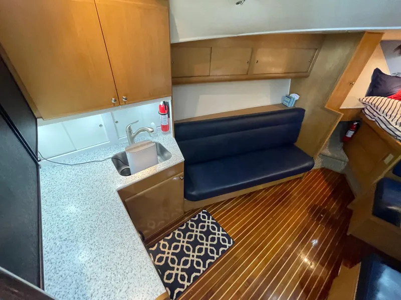 Slide: The Image of Interior of 1998 Hatteras 39 Sport Express with kitchenette and seating area. - 25