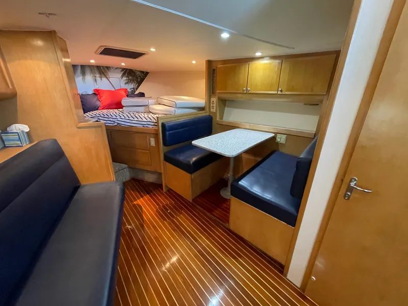 Slide: The Image of Interior of 1998 Hatteras 39 Sport Express yacht with cozy seating and wooden flooring. - 27