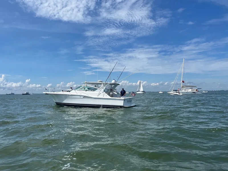 Slide: The Image of 1998 Hatteras 39 Sport Express boat on open water under blue sky. - 3
