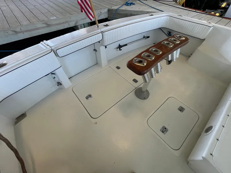 Slide: The Image of 1998 Hatteras 39 Sport Express boat deck with rod holders and storage compartments. - 30