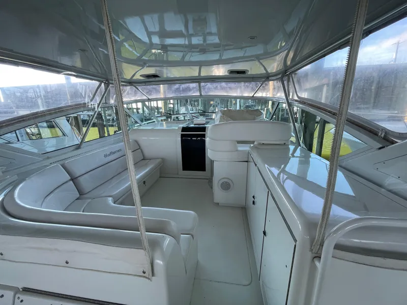 Slide: The Image of 1998 Hatteras 39 Sport Express interior with white seating and helm, showcasing luxury design. - 31