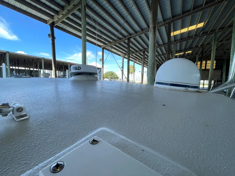 Slide: The Image of 1998 Hatteras 39 Sport Express boat under covered dock, featuring radar equipment. - 32