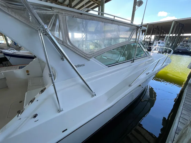 Slide: The Image of 1998 Hatteras 39 Sport Express yacht docked in marina, side view. - 35