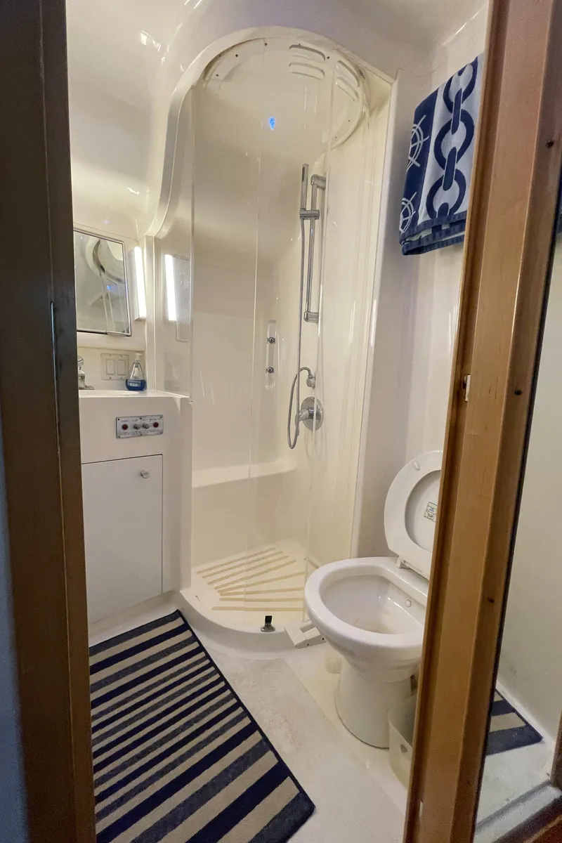 Slide: The Image of Bathroom interior of 1998 Hatteras 39 Sport Express yacht with shower and toilet. - 36