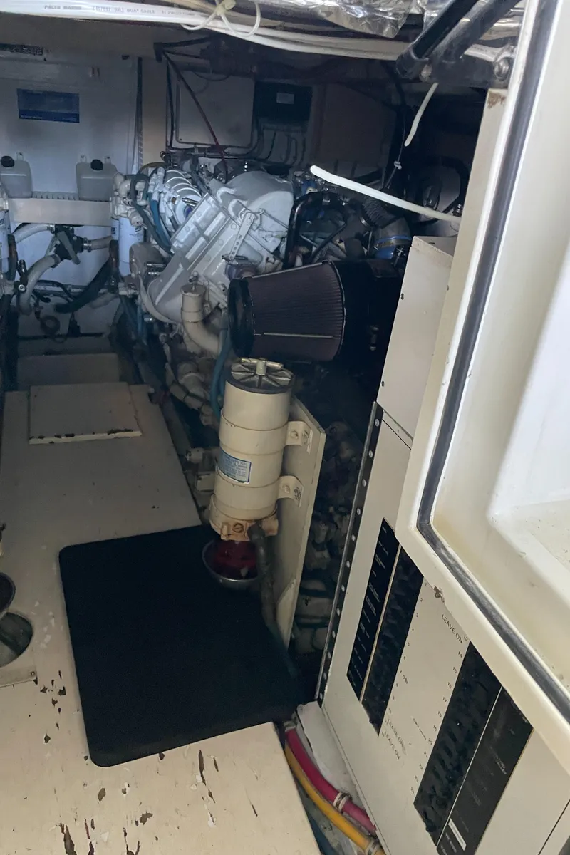 Slide: The Image of Engine room of 1998 Hatteras 39 Sport Express, showcasing mechanical components and wiring. - 39