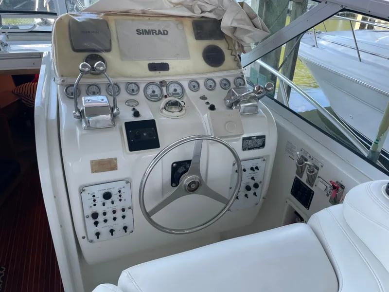 Slide: The Image of 1998 Hatteras 39 Sport Express helm with Simrad and Garmin navigation systems. - 7