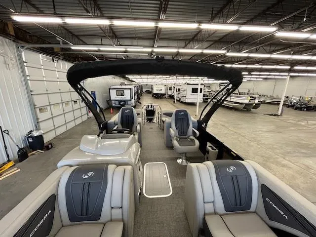 Slide: The Image of 2025 Barletta CORSA 23QC pontoon boat interior in a spacious warehouse setting. - 11