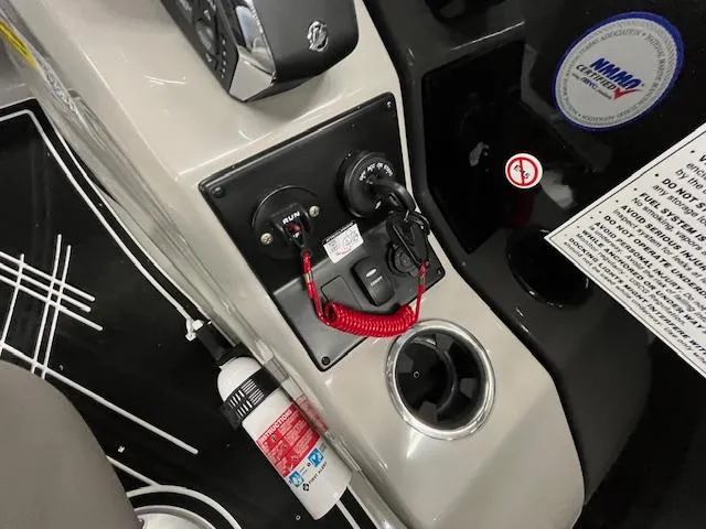 Slide: The Image of Control panel of 2025 Barletta CORSA 23QC boat with safety features and cup holder. - 14