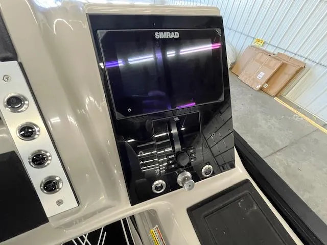 Slide: The Image of 2025 Barletta CORSA 23QC boat dashboard with Simrad display and control panel. - 15