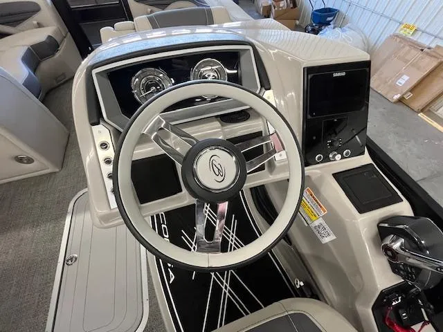 Slide: The Image of 2025 Barletta CORSA 23QC boat dashboard with steering wheel and control panel. - 17