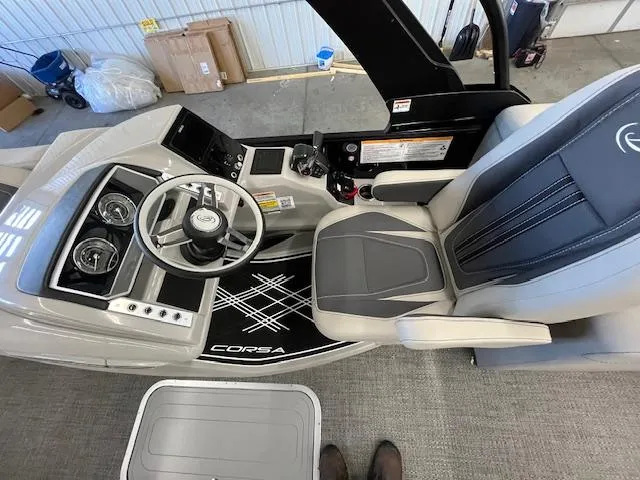 Slide: The Image of 2025 Barletta CORSA 23QC boat cockpit with steering wheel and captain's chair. - 18