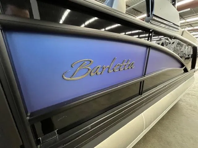 Slide: The Image of 2025 Barletta CORSA 23QC boat with sleek blue and black design. - 2