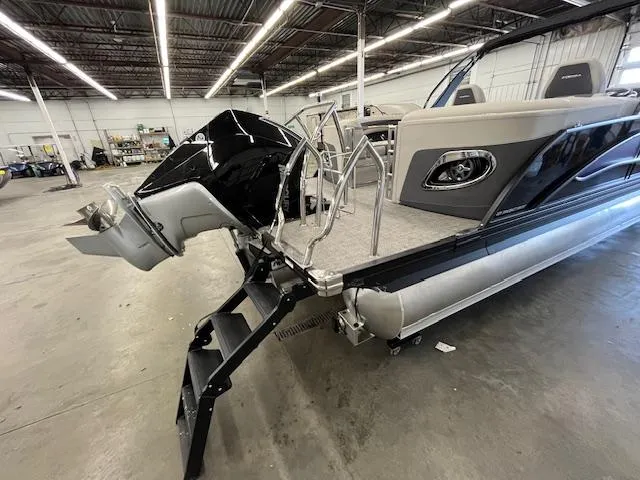 Slide: The Image of 2025 Barletta CORSA 23QC pontoon boat in warehouse, featuring sleek design and powerful outboard motor. - 25