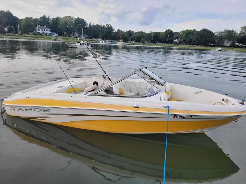 Slide: The Image of Yellow 2007 Tahoe Q6 Tracker boat docked on calm water. - 4