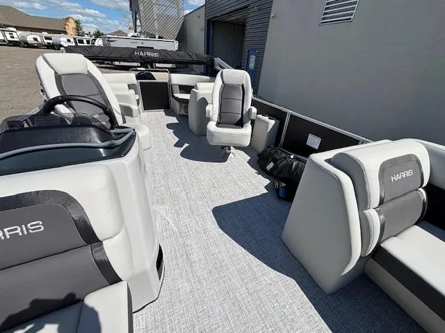 Slide: The Image of 2025 Harris Cruiser 230 pontoon boat interior with gray seating and open deck layout. - 12