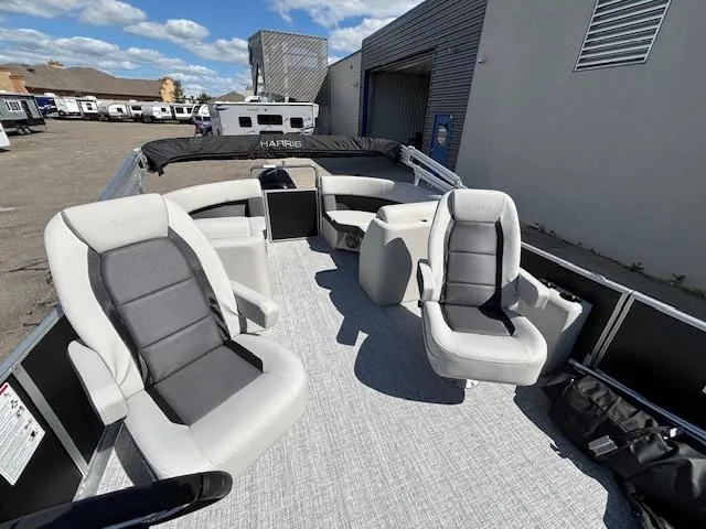 Slide: The Image of 2025 Harris Cruiser 230 pontoon boat with spacious seating and modern design. - 13