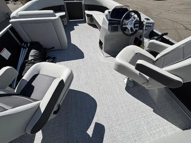 Slide: The Image of 2025 Harris Cruiser 230 boat interior with modern seating and steering console. - 17