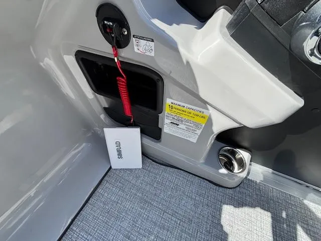 Slide: The Image of 2025 Harris Cruiser 230 boat interior with safety features and capacity label. - 20