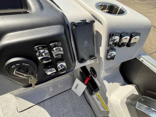 Slide: The Image of Control panel of 2025 Harris Cruiser 230 boat with key ignition and switches. - 21