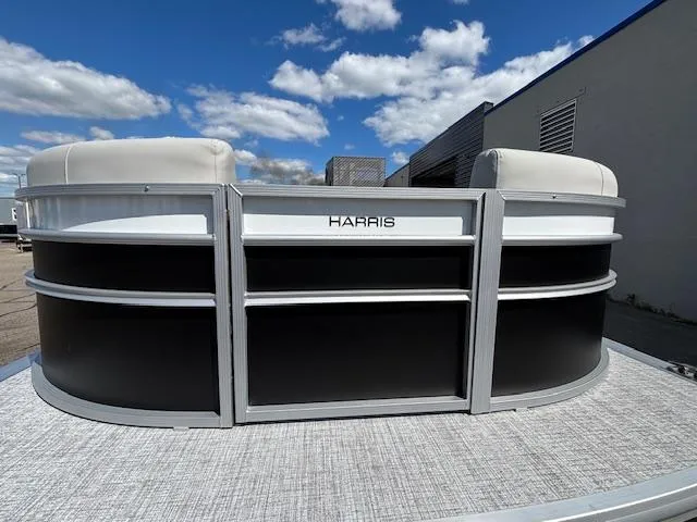 Slide: The Image of 2025 Harris Cruiser 230 pontoon boat with sleek design under a blue sky. - 3