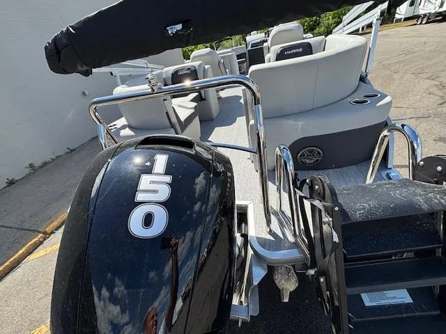 Slide: The Image of 2025 Harris Cruiser 230 boat with 150 horsepower engine, rear view. - 7