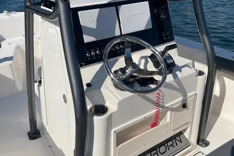 Slide: The Image of 2022 Sea Born LX24 Center Console boat with steering wheel and control panel. - 10