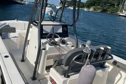 Slide: The Image of 2022 Sea Born LX24 Center Console boat on water, featuring modern helm and seating. - 11