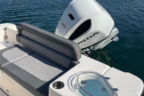 Slide: The Image of 2022 Sea Born LX24 Center Console boat with Honda outboard motor on water. - 7