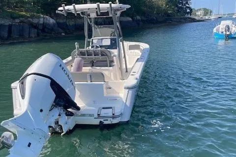 Slide: The Image of 2022 Sea Born LX24 Center Console boat on calm water near rocky shoreline. - 8