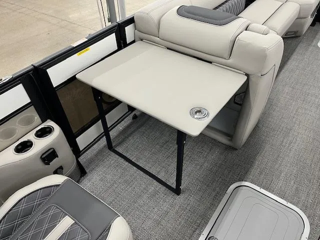 Slide: The Image of 2025 Barletta Lusso 25UC interior with foldable table and cup holders. - 10