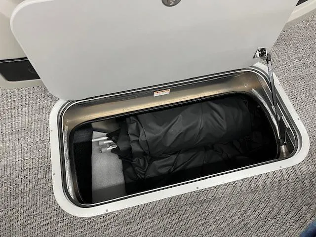 Slide: The Image of Storage compartment in 2025 Barletta Lusso 25UC boat, featuring spacious interior and secure lid. - 11