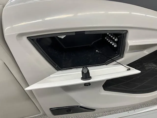 Slide: The Image of Open storage compartment in a 2025 Barletta Lusso 25UC boat interior. - 13