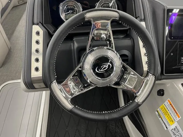 Slide: The Image of Steering wheel of 2025 Barletta Lusso 25UC boat, featuring sleek design and modern controls. - 19