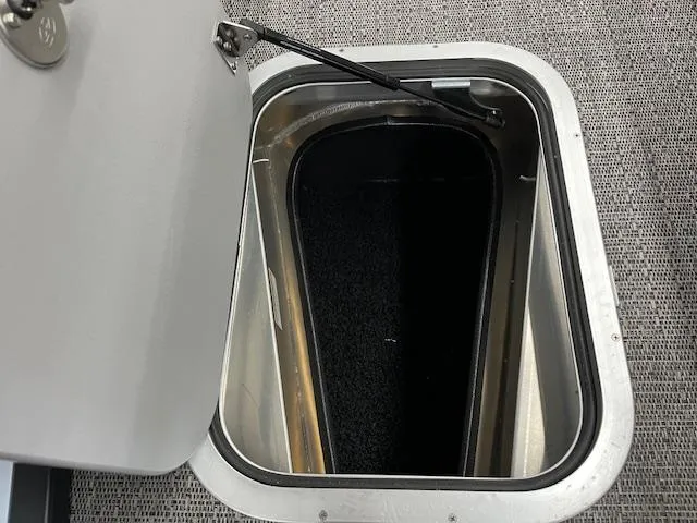 Slide: The Image of Open storage compartment on 2025 Barletta Lusso 25UC boat, featuring a sleek design. - 26